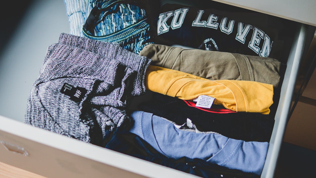 A neat arrangement of clothes and T-shirts in a drawer, showcasing casual wear.